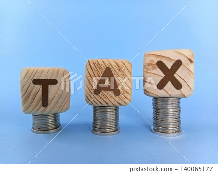 TAX illustration on wooden cubes. Business and finance concept. Selective focus TAX illustration on wooden cubes. Business and finance concept. Selective focus 140065177