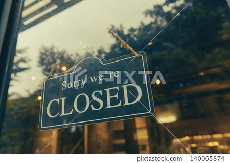 SORRY WE ARE CLOSED - Close sign broad hanging front of entrance door with copy space at coffee shop or restaurant SORRY WE ARE CLOSED - Close sign broad hanging front of entrance door with copy space at coffee shop or restaurant 140065874