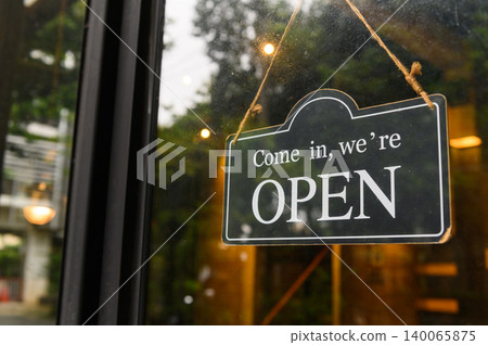 COME IN, WE ARE OPEN - Open sign broad hang on entrance door with copy space at coffee shop or restaurant 140065875