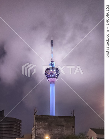 Menara KL Tower Illuminated at Night Against Cloudy Sky in Kuala Lumpur, Malaysia Menara KL Tower Illuminated at Night Against Cloudy Sky in Kuala Lumpur, Malaysia 140066152