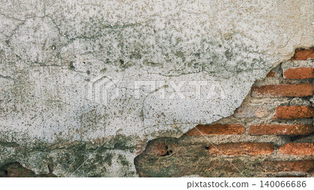 Old cracked plaster on red brick wall texture background Old cracked plaster on red brick wall texture background 140066686