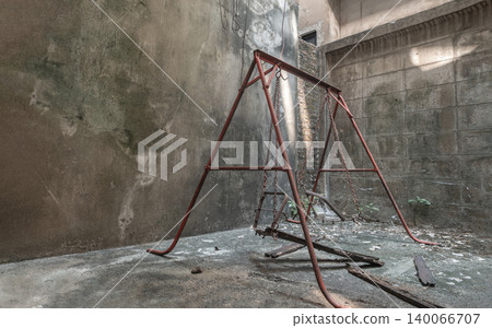 a melancholy atmosphere fills a secluded, undisturbed urban nook. A weathered red swing set stands at the center, its rusty chains and broken wooden seat resting on the ground. Towering, stained a melancholy atmosphere fills a secluded, undisturbed urban nook. A weathered red swing set stands at the center, its rusty chains and broken wooden seat resting on the ground. Towering, stained 140066707