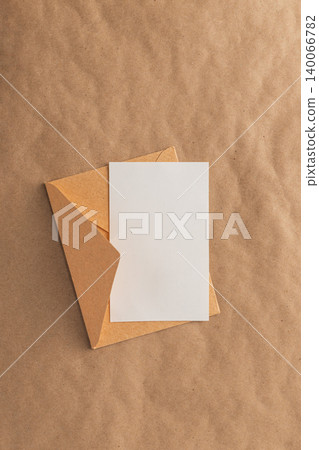 Envelope and blank card on brown kraft paper Envelope and blank card on brown kraft paper 140066782