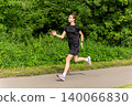 Young woman jogging on a park path 140066830
