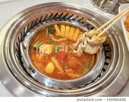 Chinese Hot Pot with Spicy Broth and Fresh Ingredients 140066886