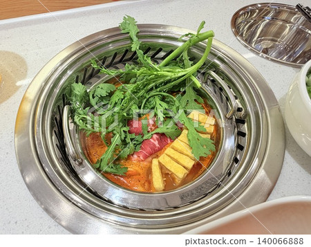 Chinese Hot Pot with Spicy Broth and Fresh Ingredients 140066888