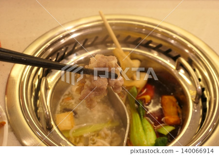 Chinese Hot Pot with Spicy Broth and Fresh Ingredients 140066914