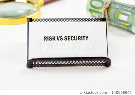 A white card stating RISK VS SECURITY stands prominently on a bright white surface 140066945