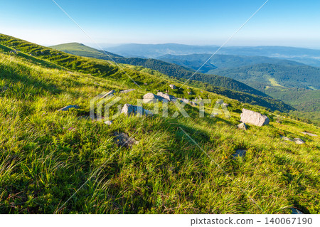 mountain landscape with grass and rock on a slope. view in to the distant valley of carpathian mountains. mountainous scenery of ukraine in summer. green environment concept for poster mountain landscape with grass and rock on a slope. view in to the distant valley of carpathian mountains. mountainous scenery of ukraine in summer. green environment concept for poster 140067190