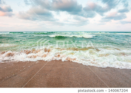 storm on the sandy beach in the afternoon. dramatic sea view with cloudy sky. salt water and crashing waves. view of bulgaria beach in summer. wind weather background storm on the sandy beach in the afternoon. dramatic sea view with cloudy sky. salt water and crashing waves. view of bulgaria beach in summer. wind weather background 140067204