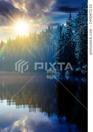 day meet night on quiet lake. sun and moon over coniferous forest reflecting on the calm body of water. epic place in national park. summer nature background image for astrology wallpaper concept day meet night on quiet lake. sun and moon over coniferous forest reflecting on the calm body of water. epic place in national park. summer nature background image for astrology wallpaper concept 140067210