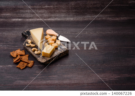 Aged cheese in a triangular block with jam, figs, and nuts. Aged cheese 140067226