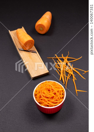 Shredding carrots for a healthy and nutritious meal Shredding carrots for a healthy and nutritious meal 140067381