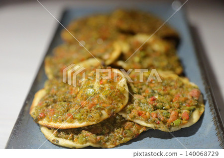 Turkish lahmacun kebap, one of the most important dishes of Turkish cuisine, delicious and traditional turkish pizza. close up. selective focus. Turkish lahmacun kebap, one of the most important dishes of Turkish cuisine, delicious and traditional turkish pizza. close up. selective focus. 140068729