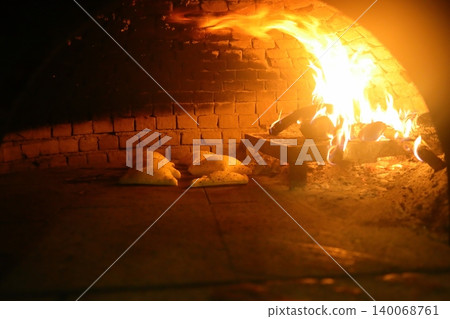 Old style middle east stone oven with flat bread with different spices inside Old style middle east stone oven with flat bread with different spices inside 140068761