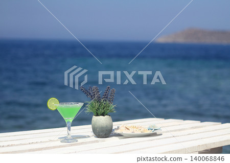 Summer cocktail on the background of the sea. Summer vacation, relaxation, summer party. Summer cocktail on the background of the sea. Summer vacation, relaxation, summer party. 140068846