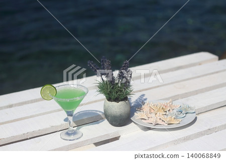 Summer cocktail on the background of the  sea. Summer vacation, relaxation, summer party. 140068849