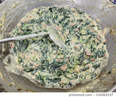 Cooking Creamy Spinach with Ham in a Large Metal Pan for Homemade Meal Cooking Creamy Spinach with Ham in a Large Metal Pan for Homemade Meal 140069297