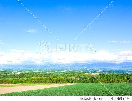 A view from the roller coaster road in Kamifurano Town, Hokkaido, during the summer. A view from the roller coaster road in Kamifurano Town, Hokkaido, during the summer. 140069549