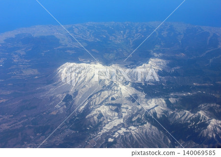 Snow-covered mountains from an airplane Snow-covered mountains from an airplane 140069585