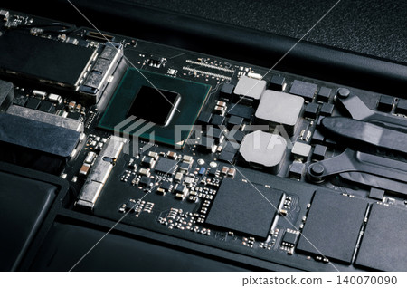 Close-up part of motherboard from laptop computer show up a CPU and other components on board 140070090