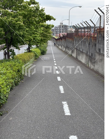 A scene of students walking home from school, on a road. 140070641