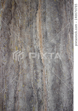 Travertine marble wall with porous vertical grain in grey and beige. Travertine marble wall with porous vertical grain in grey and beige. 140070785