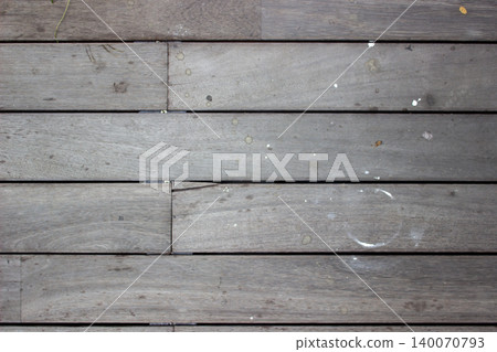 Grayish brown wooden decking floor with white stain spots. Grayish brown wooden decking floor with white stain spots. 140070793