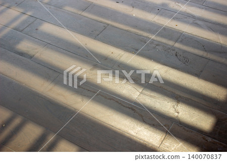 Gray tile floor texture with horizontal geometric shadow patterns. Gray tile floor texture with horizontal geometric shadow patterns. 140070837