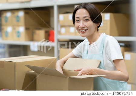 Middle-aged woman working in a warehouse Middle-aged woman working in a warehouse 140071734