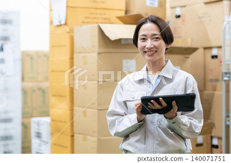 Middle-aged female worker in a warehouse Middle-aged female worker in a warehouse 140071751