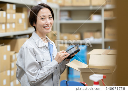 Middle-aged female worker in a warehouse Middle-aged female worker in a warehouse 140071756