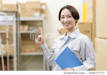 Middle-aged female worker in a warehouse Middle-aged female worker in a warehouse 140071777