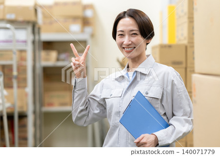 Middle-aged female worker in a warehouse Middle-aged female worker in a warehouse 140071779