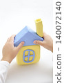 Hands supporting a model house: Images of a dream home and real estate. 140072140