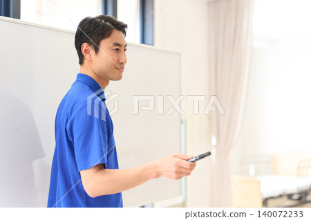 Asian caregivers training new recruits at a nursing home 140072233