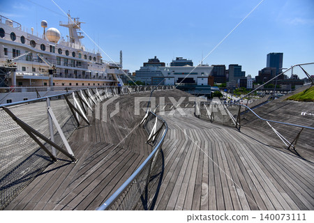 A refreshing early summer blue sky and a cruise ship viewed from the wooden deck of Yokohama Osanbashi Pier. A refreshing early summer blue sky and a cruise ship viewed from the wooden deck of Yokohama Osanbashi Pier. 140073111