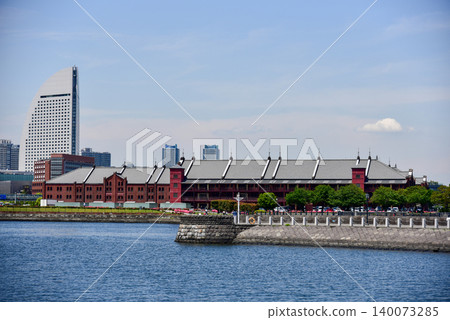 Summer scenery of Yokohama Red Brick Warehouse and Minato Mirai under a clear blue sky. Summer scenery of Yokohama Red Brick Warehouse and Minato Mirai under a clear blue sky. 140073285