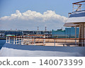 A view of Yokohama Port in summer, with its blue sky and towering cumulonimbus clouds, from the deck of a cruise ship. 140073399