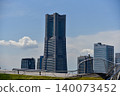 Yokohama Landmark Tower and the Minato Mirai skyline stand tall against the blue sky. 140073452