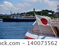 Under a blue sky, the stern of the luxury cruise ship "Nippon Maru" and the Japanese flag are visible as the ship is docked in Yokohama Port. 140073562