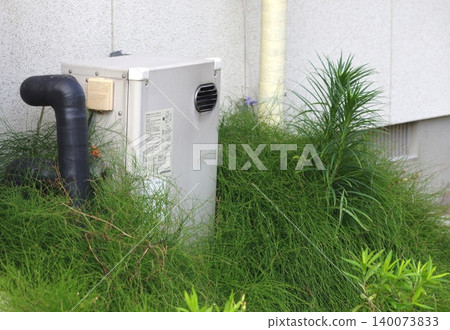 The appearance of weeds growing around the water heater The appearance of weeds growing around the water heater 140073833