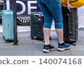 Foreign tourists riding in a Tokyo cityscape taxi... suitcases go into the rear trunk. 140074168