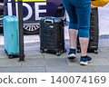 Foreign tourists riding in a Tokyo cityscape taxi... suitcases go into the rear trunk. 140074169