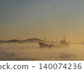 A ship passing birds in the early morning sea fog. 140074236