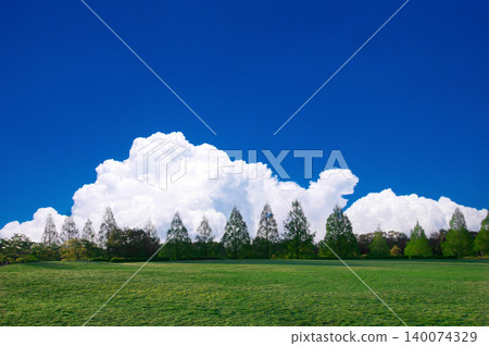 A landscape of green hills with a blue sky and white clouds. A landscape of green hills with a blue sky and white clouds. 140074329