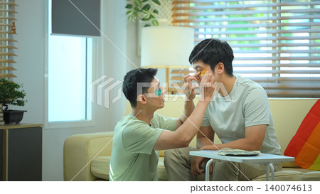 LGBTQ partners sharing skincare routine together applying eye mask LGBTQ partners sharing skincare routine together applying eye mask 140074613