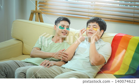 LGBTQ partners enjoying skincare and rest together relaxing with eye masks at home LGBTQ partners enjoying skincare and rest together relaxing with eye masks at home 140074622