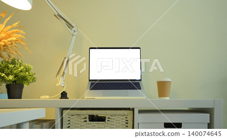 Minimal desk with laptop mockup coffee and lamp in clean workspace 140074645