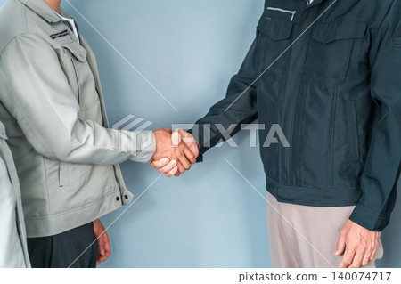 Two businessmen in work clothes shake hands (contract, cooperation, collaboration, business, partnership) 140074717